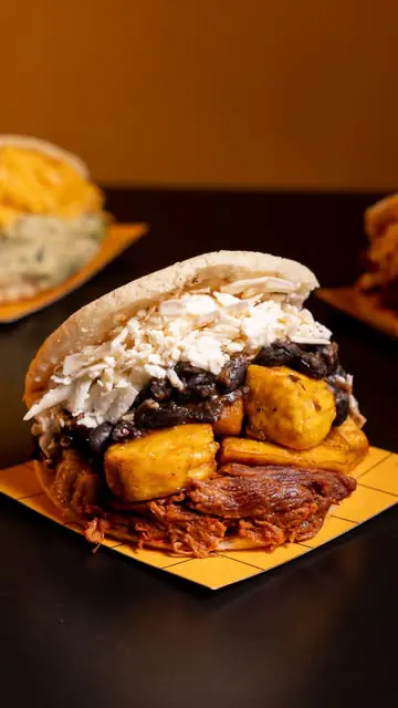 Arepa rellena hasta arriba con carne y queso